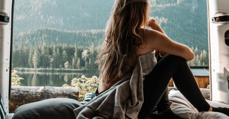 Van Life - Woman in the Back of a Van Looking at Mountains