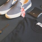 Fashion Brands - Pair of Gray Vans Low-top Sneakers Beside Black Shirt, Sunglasses, and Watch