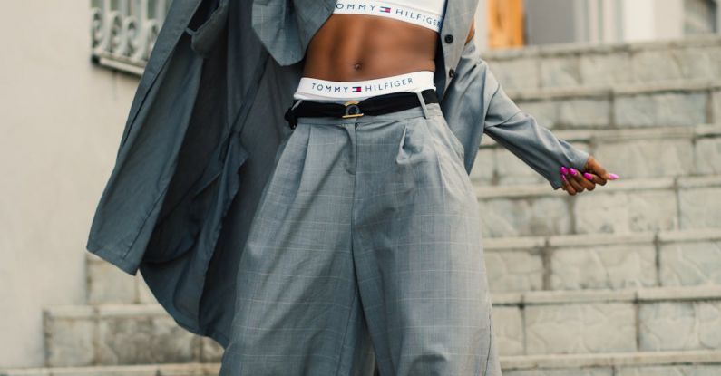 Personalized Clothing - Woman in Gray Blazer Stands on Gray Concrete Floor