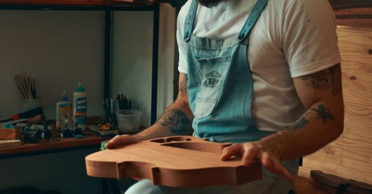 Viral Music - A man in overalls sitting in a chair with a guitar