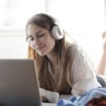 Music Streaming Services - Woman in White Shirt Using Silver Macbook