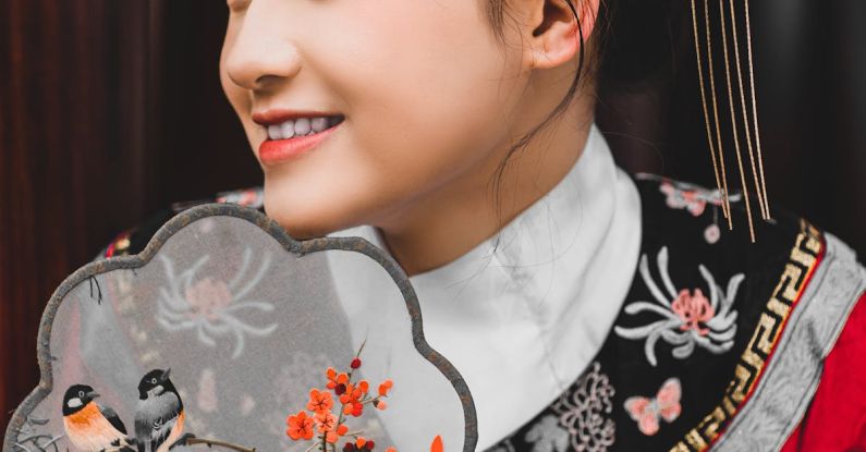 Fan Fiction - A young woman in traditional chinese clothing holding a fan