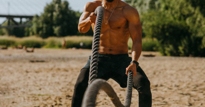 Outdoor Workouts - Man Training Outdoor Using Battle Ropes