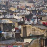 Overpopulation - Poor Building Rooftops with Satellite Antennas