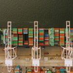 Drone Delivery Systems - Colorful cargo containers on ship near pier