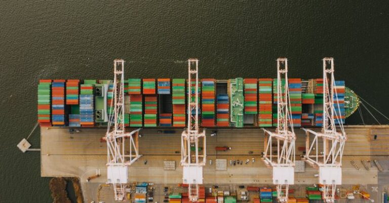 Drone Delivery Systems - Colorful cargo containers on ship near pier