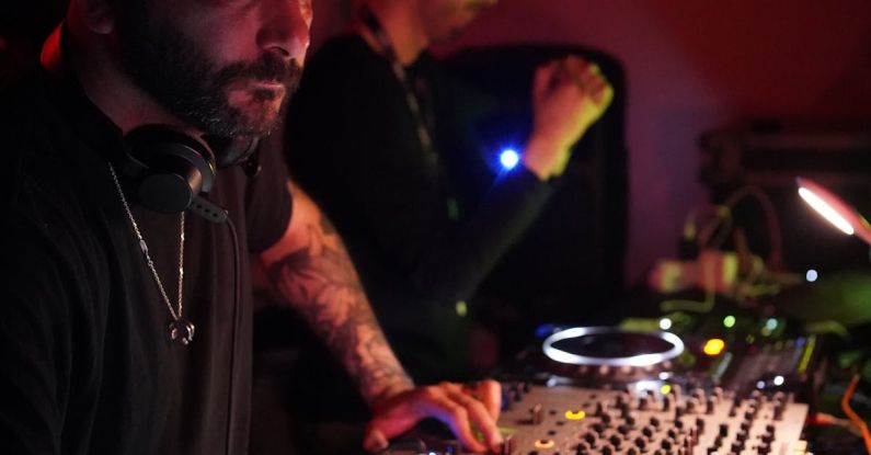 Genetic Editing - A man with a beard and tattoos playing music