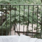 Travel Blogging - Laptop On Bed Near The Balcony